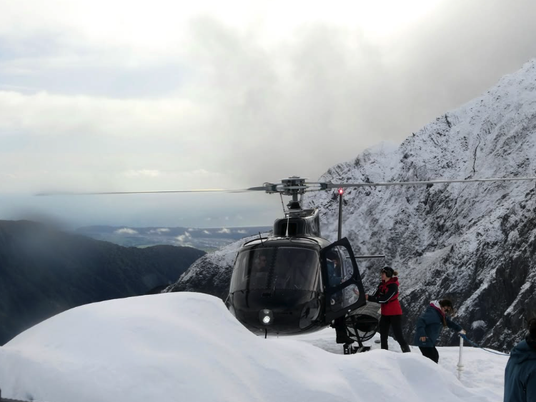 Helicopter climbing over the Franz Josef icefalls